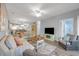 Cozy living room with a plush sofa, stylish decor, and an open layout to the dining and kitchen areas at 601 N Hillside Dr. # 2235, North Myrtle Beach, SC 29582