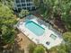 Birds-eye view of a pool and spa surrounded by lounge chairs and lush trees at 601 N Hillside Dr. # 2235, North Myrtle Beach, SC 29582