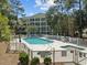 A refreshing swimming pool with spa, lounge chairs, and lush greenery for relaxing outdoors at 601 N Hillside Dr. # 2235, North Myrtle Beach, SC 29582