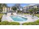 Community pool and lounging area surrounded by lush landscaping and white picket fence at 601 N Hillside Dr. # 2235, North Myrtle Beach, SC 29582