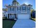 Charming two-story home with a concrete driveway and manicured lawn at 6011 Forest Dell Ct, Myrtle Beach, SC 29579