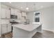 Bright kitchen with white cabinets, an island with quartz countertop, and stainless steel appliances at 6011 Forest Dell Ct, Myrtle Beach, SC 29579