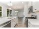 Open concept kitchen with stainless steel appliances, island sink and view to dining and living areas at 6011 Forest Dell Ct, Myrtle Beach, SC 29579