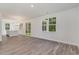 Bright living room boasts luxury vinyl plank flooring, large windows and an open-concept design at 6011 Forest Dell Ct, Myrtle Beach, SC 29579