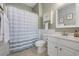Well-lit bathroom with wainscoting, neutral tile floor and tub with shower at 6015 Catalina Dr. # 914, North Myrtle Beach, SC 29582