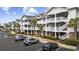Beautiful condo building with multiple stories, exterior stairs, and a manicured landscape at 6015 Catalina Dr. # 914, North Myrtle Beach, SC 29582