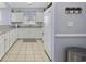 Well-lit kitchen featuring white cabinets, granite countertops, and tile flooring at 6015 Catalina Dr. # 914, North Myrtle Beach, SC 29582