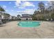 Great view of a sparking swimming pool with an adjacent building for residents, surrounded by palm trees at 6015 Catalina Dr. # 914, North Myrtle Beach, SC 29582
