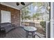 Cozy screened porch with brick accents, seating, and views of the outdoors at 6015 Catalina Dr. # 914, North Myrtle Beach, SC 29582