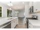 Well-lit kitchen showcases a large island, stainless steel appliances, and an open layout leading to the living area at 6031 Forest Dell Ct, Myrtle Beach, SC 29579