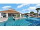 Stunning pool area with inviting blue water and a covered lounge, perfect for relaxation and entertainment at 6031 Forest Dell Ct, Myrtle Beach, SC 29579