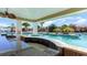 This covered outdoor kitchen features a view of the pool at 6031 Forest Dell Ct, Myrtle Beach, SC 29579