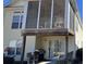 View of outdoor space with screened porch, patio with grill, and view of a large window at 670 2Nd Ave. N, North Myrtle Beach, SC 29582