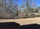 Backyard landscape with water feature surrounded by cypress trees and foliage at 670 2Nd Ave. N, North Myrtle Beach, SC 29582