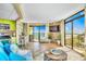 Open-concept living area with tile floors, stone accent wall, and sliding glass doors with ocean view at 6804 N Ocean Blvd. # 1639, Myrtle Beach, SC 29572