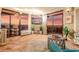 Bright living room with tile floors, stone accent wall, large sliding glass doors and sunset view at 6804 N Ocean Blvd. # 1639, Myrtle Beach, SC 29572