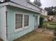 Side view of exterior with muted green siding, window, and exterior door, number 7 at 7 Century St. # 7, Myrtle Beach, SC 29577