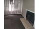 Cozy living room space features plush carpeting, a decorative fireplace, and neutral paint at 7 Century St. # 7, Myrtle Beach, SC 29577