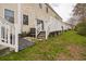 Backyard patio with stairs, and fenced-in yard with well-maintained lawn at 705 Beach Walk Pl. # 705, Myrtle Beach, SC 29577