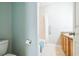 Bright bathroom features a tiled shower, a toilet, and granite countertops at 705 Beach Walk Pl. # 705, Myrtle Beach, SC 29577