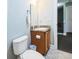 Bright bathroom with toilet, vanity with granite countertop, mirror, and tile flooring at 705 Beach Walk Pl. # 705, Myrtle Beach, SC 29577