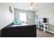 Comfortable bedroom with desk, chair, and a window letting in natural light at 705 Beach Walk Pl. # 705, Myrtle Beach, SC 29577