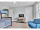 Cozy bedroom featuring a bunk bed, TV on a wooden stand, and comfortable blue armchair at 705 Beach Walk Pl. # 705, Myrtle Beach, SC 29577