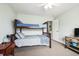 Charming bedroom showcasing a bunk bed with blue and grey bedding and a wooden desk at 705 Beach Walk Pl. # 705, Myrtle Beach, SC 29577