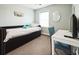 Sun-filled bedroom featuring a stylish bed and a modern desk with a comfortable chair at 705 Beach Walk Pl. # 705, Myrtle Beach, SC 29577