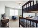 Bright bedroom boasts a bunk bed, cozy blue armchair, and lots of natural light from the window at 705 Beach Walk Pl. # 705, Myrtle Beach, SC 29577