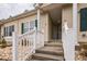 Welcoming entrance to townhouse with decorative rock landscaping, painted steps and crisp white railings at 705 Beach Walk Pl. # 705, Myrtle Beach, SC 29577