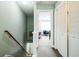 Hallway view with access to a bedroom featuring a comfortable blue chair and closet with shuttered doors at 705 Beach Walk Pl. # 705, Myrtle Beach, SC 29577