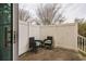 Cozy patio featuring two chairs, a small table, and a white privacy fence, perfect for relaxing outdoors at 705 Beach Walk Pl. # 705, Myrtle Beach, SC 29577