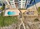 Aerial view of the building with a kidney bean-shaped pool, and beach access at 707 S Ocean Blvd. # 304, North Myrtle Beach, SC 29582