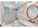 Bright bathroom with a shower-tub combo, and an oval mirror over the vanity at 707 S Ocean Blvd. # 304, North Myrtle Beach, SC 29582