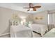 Comfortable bedroom featuring two twin beds, ceiling fan and pastel decor at 707 S Ocean Blvd. # 304, North Myrtle Beach, SC 29582