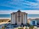 Oceanfront building with multiple stories, beach access, parking, and attractive curb appeal at 707 S Ocean Blvd. # 304, North Myrtle Beach, SC 29582