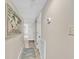 Hallway leading to rooms with tiled floors and beach-themed wall art at 707 S Ocean Blvd. # 304, North Myrtle Beach, SC 29582