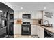 Bright kitchen boasts white cabinets, black appliances, and a decorative backsplash at 707 S Ocean Blvd. # 304, North Myrtle Beach, SC 29582