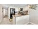 Galley kitchen with tile floors, granite counters and stainless appliances provides a fully functional space at 707 S Ocean Blvd. # 304, North Myrtle Beach, SC 29582
