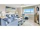 Living room boasts stylish blue seating, an ocean view, and coastal décor for a relaxing atmosphere at 707 S Ocean Blvd. # 304, North Myrtle Beach, SC 29582
