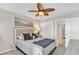 Comfortable bedroom featuring a ceiling fan, ocean-themed art, and ample closet space at 707 S Ocean Blvd. # 304, North Myrtle Beach, SC 29582