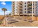 Enjoy the beautiful outdoor pool area with lounge chairs in front of a beachfront condominium at 707 S Ocean Blvd. # 304, North Myrtle Beach, SC 29582