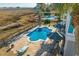 Aerial view of a backyard featuring a swimming pool, lounge chairs, and outdoor seating at 728 Elizabeth Dr., Murrells Inlet, SC 29576