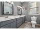 Bathroom features dual sink vanity, decorative mirrors, and wood-look tile at 728 Elizabeth Dr., Murrells Inlet, SC 29576