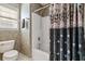 Cozy bathroom featuring a shower-tub combination and decorative wallpaper at 728 Elizabeth Dr., Murrells Inlet, SC 29576