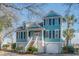 Charming two-story beach house with a welcoming front porch and well-maintained landscaping at 728 Elizabeth Dr., Murrells Inlet, SC 29576