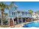 Multi-story home featuring a large swimming pool, spacious deck, and stairs to backyard at 728 Elizabeth Dr., Murrells Inlet, SC 29576