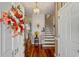 Inviting foyer with hardwood floors, staircase, and decorative wreath on the front door at 728 Elizabeth Dr., Murrells Inlet, SC 29576