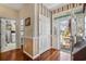 Inviting home foyer with hardwood floors, white trim, and an open doorway at 728 Elizabeth Dr., Murrells Inlet, SC 29576